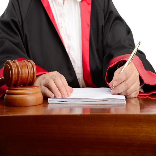 Female judge writing the verdict isolated on white background