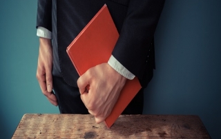 Man with book at desk