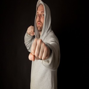 Man in hodded jumper fighting pose