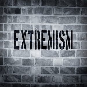 Extremism stencil print on the grunge white brick wall